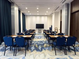 a conference room with tables and chairs and a projection screen at Surxondaryo Hotel Tashkent in Teshabayguzar +45 photos