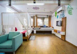 a living room with a bed and a couch and a couch at Saga by Lake in Udaipur