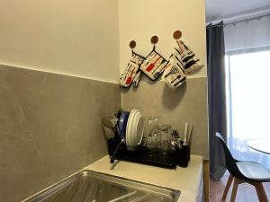 a kitchen counter with plates and utensils on a wall at FK studio in Abidjan