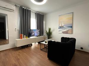 a living room with a couch and a tv at FK studio in Abidjan