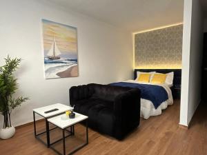 a living room with a couch and a bed at FK studio in Abidjan
