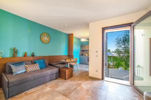 a living room with blue walls and a couch at Alternative Resort & SPA in Scorrano
