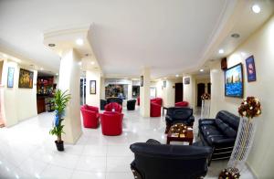a lobby with black leather furniture and red chairs at Hotel Eylül in Erdemli +21 photos