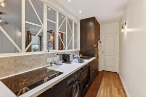 a kitchen with a sink and a counter top at Premium 1BR flat with direct access to the RER B in Gentilly