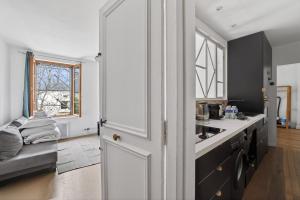 a kitchen with a white door and a sink at Premium 1BR flat with direct access to the RER B in Gentilly