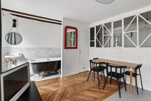 a kitchen and dining room with a table and chairs at Premium 1BR flat with direct access to the RER B in Gentilly