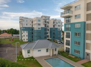 an apartment building with a pool in front of it at Luxury suites 2 in Kingston