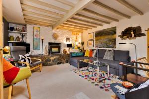 a living room with a couch and a fireplace at Finest Retreats - Wallis Cottage in Fishguard