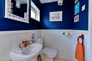 a bathroom with a white toilet and a sink at Finest Retreats - Wallis Cottage in Fishguard +23 photos