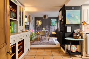 a kitchen with a table and a dining room at Finest Retreats - Wallis Cottage in Fishguard