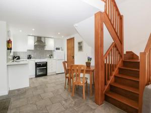 a kitchen and dining room with a table and chairs at Horse Gin in Lydney