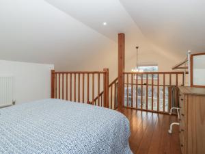 a bedroom with a bed and a balcony at Horse Gin in Lydney