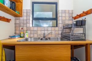 a kitchen counter with a sink and a window at High Tide Seafront at Franskraal in Franskraalstrand +29 photos