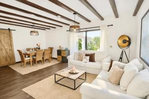 a living room with white furniture and a table at Lo Exclusive Denia Els Poblets - Villa with private pool near to beach in Els Poblets