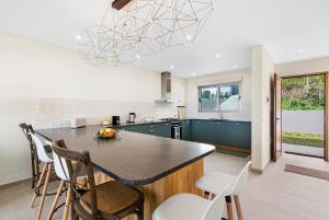 a kitchen with a island with chairs and a counter top at Casa da boa vista in Canhas