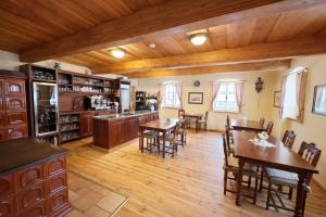 a large kitchen with wooden floors and wooden ceilings at U Bílého koníka in Kostelní Bříza +9 photos
