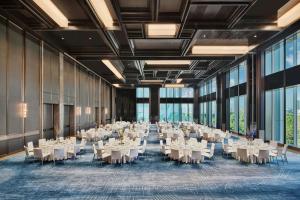 a banquet hall with white tables and chairs at Le Meridien Nantong in Nantong +121 photos