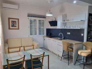 a kitchen with a table and chairs and a sink at La Campagne Ioannina Kranoula in Ioannina