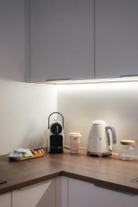 a kitchen with a counter top with a toaster and a appliance at Hôtel & Suites San Roccu in Saint-Florent