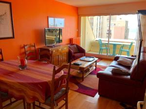 a living room with a table and a couch at Le Balcon de la Conchée in Saint Malo