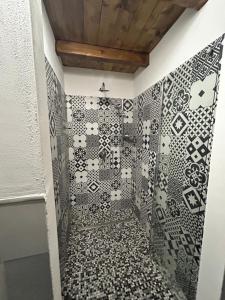 a bathroom with black and white tiles on the wall at MILANO Central Station House in Milan +28 photos
