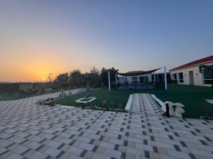 a person riding a skateboard in the yard of a house at Private farm Pool games Ras alkhaimah in Maghribīyah