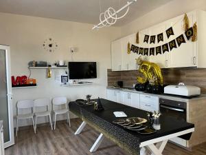 a kitchen with a table and chairs in a room at Villetta della Pace nel cuore del Salento in Torre Santa Susanna +19 photos