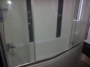 a bathroom with a shower with a glass at Vesta Fuar Otel in Konak