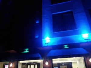 a building with blue lights on it at night at Vesta Fuar Otel in Konak