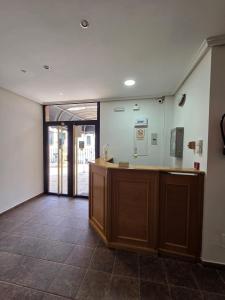 a lobby with a reception desk in a building at Hostal Don Juan Meco in Meco