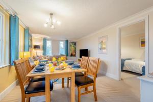 a dining room with a table and chairs and a couch at 2 Bed in Sandhurst oc-o34807 in Sandhurst