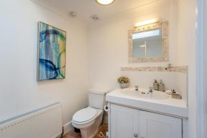 a bathroom with a toilet and a sink and a mirror at 2 Bed in Sandhurst oc-o34807 in Sandhurst +15 photos