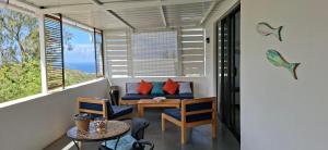 a room with a table and chairs and a window at Villa Ti Zil in Rodrigues Island