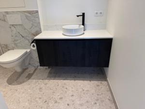 a bathroom with a toilet and a sink at The Corner -FRANS in Beernem +38 photos