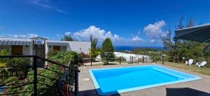 a swimming pool with a view of the ocean at Villa Ti Zil in Rodrigues Island
