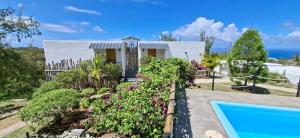 a house with a garden and a swimming pool at Villa Ti Zil in Rodrigues Island +32 photos