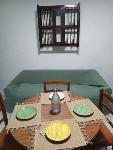 a table with two plates and a vase on it at Casa Lara - Sierra de Cazorla in Quesada +23 photos