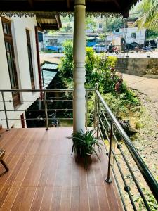 a porch with a plant sitting on top of it at D2 Holiday Inn in Badulla