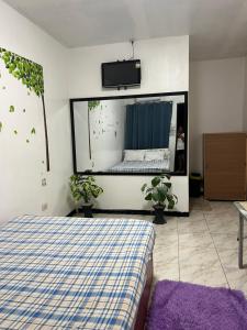 a bedroom with a bed and a tv on the wall at 88 Inn in Upper Katungal