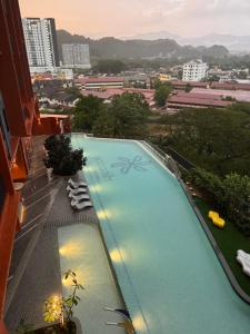a large swimming pool on top of a building at Piccadilly Greentown Ipoh by Jun - City Views in Ipoh