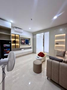 a living room with a couch and a tv at Phú Tài Central Life in Quy Nhon
