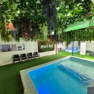 a room with a swimming pool with chairs and plants at Casa Rural Mayné in Villafranca de los Caballeros