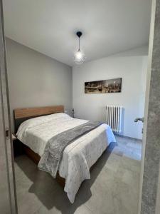 a bedroom with a bed and a painting on the wall at The Blue Sky Apartment with Lake view in Pianello Del Lario