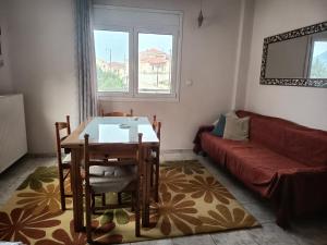 a living room with a table and a couch at Vagelis 2 Nemea apartments in Neméa