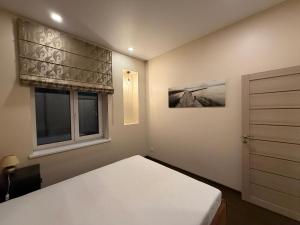 a bedroom with a bed and a window at Kęstučio 66 apartamentai in Kaunas
