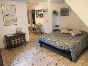 a bedroom with a bed and a table at Bel Horizon in La Celle-sous-Gouzon