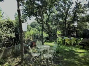 a group of tables and chairs in a yard at Bel Horizon in La Celle-sous-Gouzon