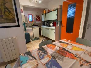 a kitchen with a dining room table and a kitchen with at Bel Horizon in La Celle-sous-Gouzon