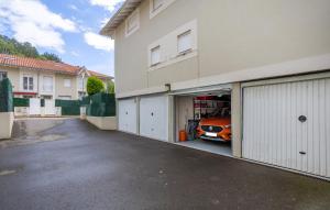 a garage with an orange car inside of it at Chalet adosado con piscina en el Valle de Asón LA TUDANCA in Arredondo +53 photos