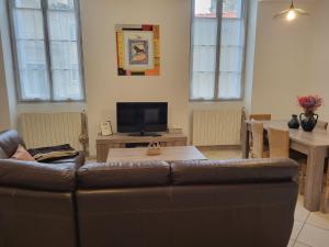 a living room with a couch and a table at entre arènes et maison carrée in Nîmes